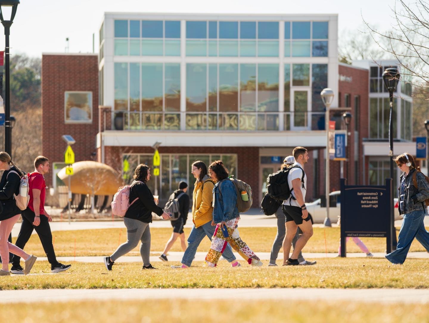 campus scene fall , students passing on the mall 